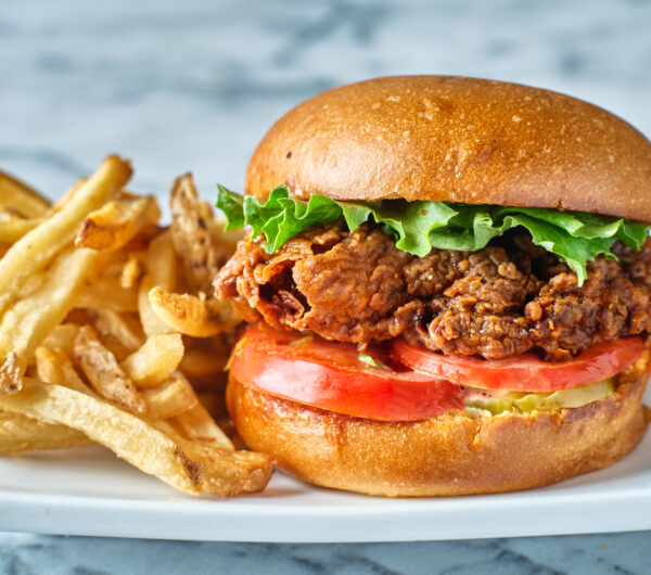 crispy fried chicken sandwich on brioche bun with french fries